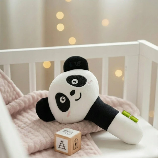 Przytulanka piszczałka Panda Bocioland przy łóżeczku